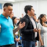 A congregation of people praying inside a church in Mexico City.